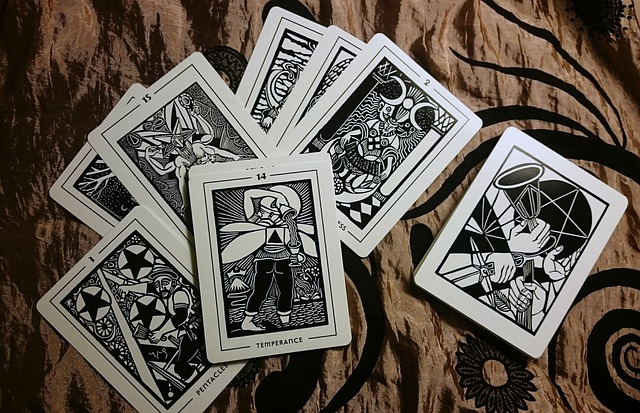 Black and white Tarot cards spread on a cloth