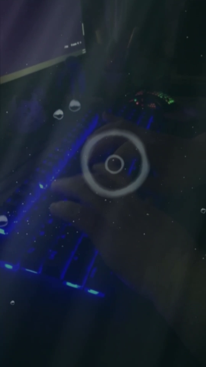 A person typing on a glowing keyboard underwater