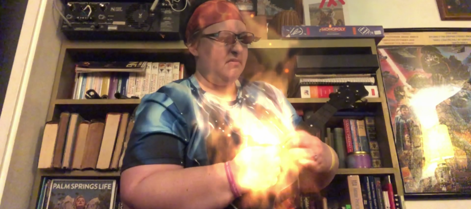 A person "shredding" on a ukelele which is producing magical fire