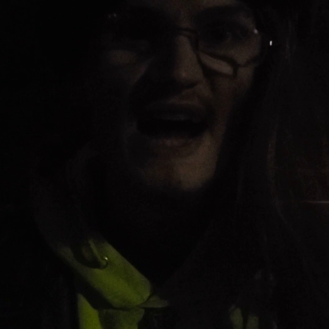 A young man, possibly a zombie, snarling at the camera