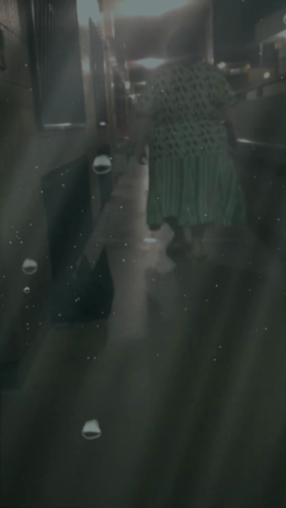 A woman in a skirt walking down a hallway with a keyboard in hand, underwater effect applied