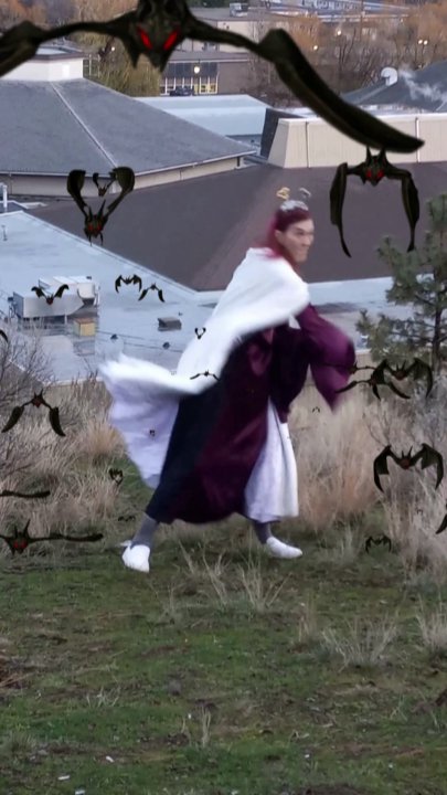 A woman fighting with a sword while bats fly at the camera